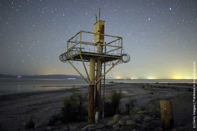 Stars are seen in abundance over a disused structure, on the shore of the Salton Sea