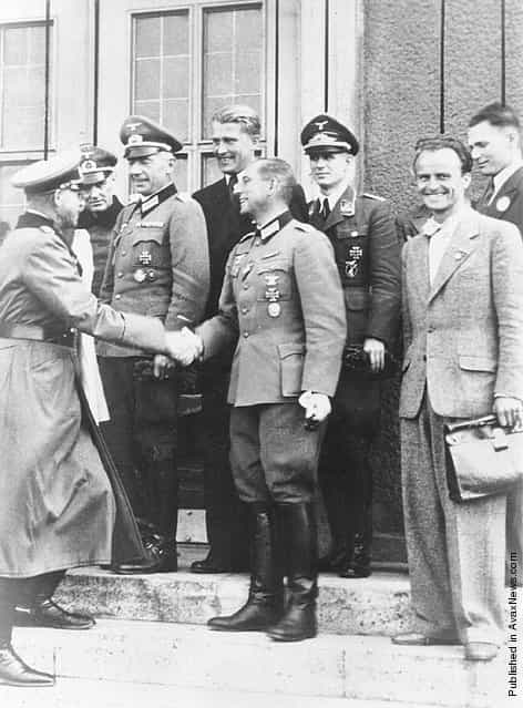 General Erich Fellgiebel, head of the German Army Information Service during World War II, congratulates members of the von Braun rocket team from Peenemunde for their October 3, 1942 A4 flight. Pictured front center is General Erich Fellgiebel