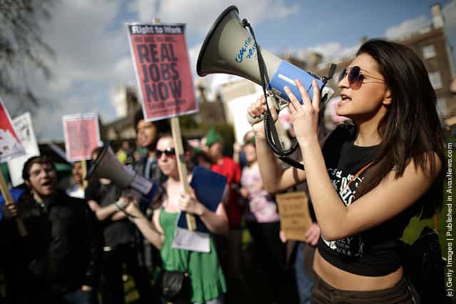 Demonstrators gather on College Green opposite the Houses of Parliament to protest against the Government's austerity measures as the Chancellor of the Exchequer George Osborne presents his annual budget to Parliament in London