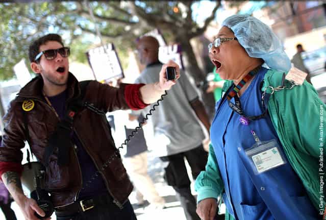 Nurse Inez Banks (R) yells into a megaphone as she protests outside of San Francisco General Hospital