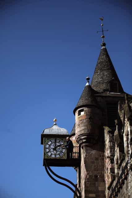 Alan Wilson, Director of James Ritchie & Son clockmakers, founded in 1809, adjusts a clock face at the Cannongate Tobooth to British Summer Time in Edinburgh