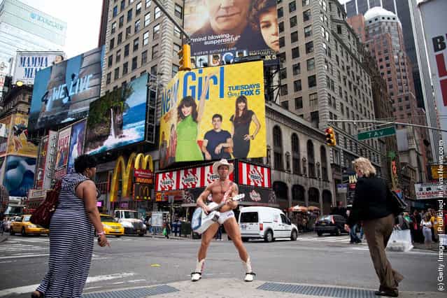 The Naked Cowboy plays his guitar in Times Square on March 23, 2012 in New York City