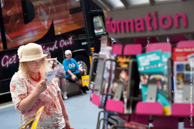 A woman reads a flyer from an information booth in Times Square on March 23, 2012 in New York City