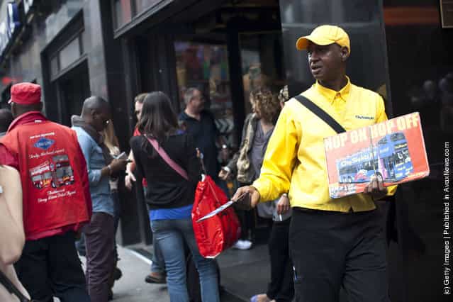 A City SightsNY worker hands out flyers to people in Times Square