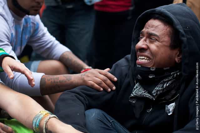 An Occupy Wall Street protester is consoled while crying in Union Square at the end of a march from Zuccotti Park to Union Square