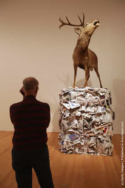 A visitor looks at a work by artist Gloria Friedmann at the exhibition ARTandPRESS at Martin Gropius Bau
