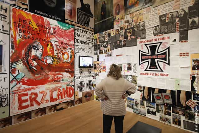 A visitor looks at an installation by artist Jonathan Meese at the exhibition ARTandPRESS at Martin Gropius Bau