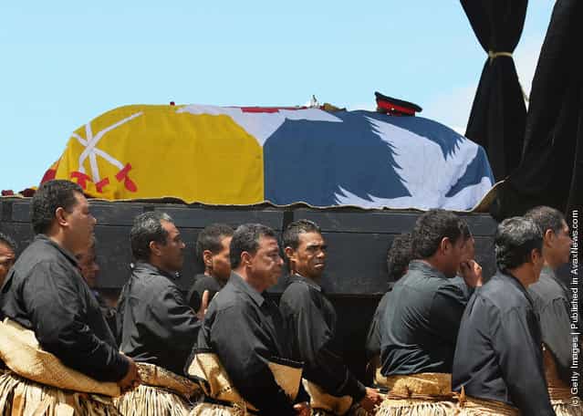 The Royal casket of King George Tupou V is carried towards the Royal Tombs during the State Funeral held for King George Tupou V at Malaekula