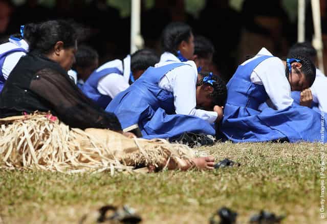 School girls taking part in the royal funeral struggle in the heat during the State Funeral held for King George Tupou V at Malaekula