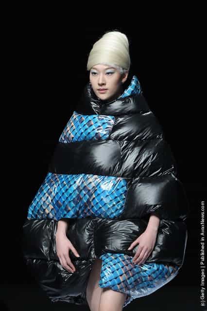 A model showcases designs on the catwalk during OudiFu Collection A/W 2012-2013 of China Fashion Week