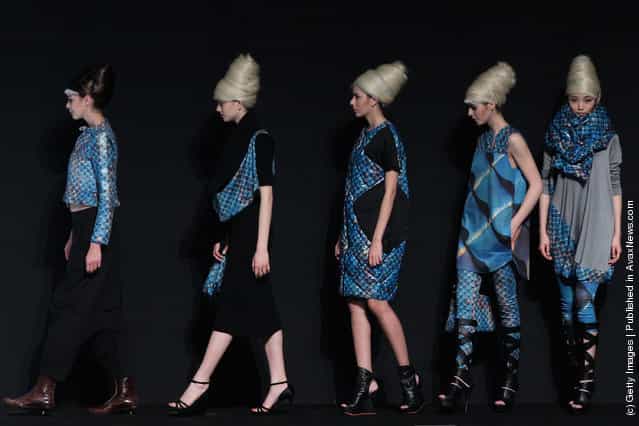 Models showcase designs on the catwalk during OudiFu Collection A/W 2012-2013 of China Fashion Week at Beijing Hotel