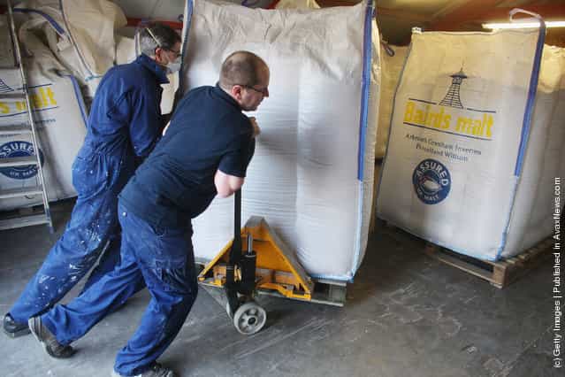 Jimmy Kennedy and Bose Mathias bring in a delivery of malt at Edradour distillery on March 26, 2012 in Pitlochry, UK
