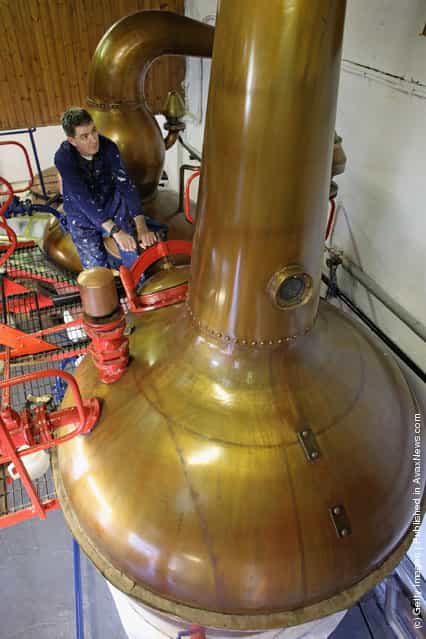 Jimmy Kennedy, works on a copper still at Edradour distillery on March 26, 2012 in Pitlochry, United Kingdom