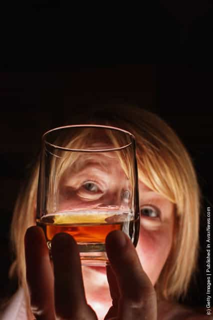 Julie Cameron tour guide holds a glass of whisky at Edradour distillery on March 26, 2012 in Pitlochry, United Kingdom