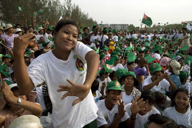 Burmese cheer at a rally with the government sponsored Union Solidarity and Development Party (USDP) by former military general, and General Secretary U Htay Oo ahead of the parliamentary elections
