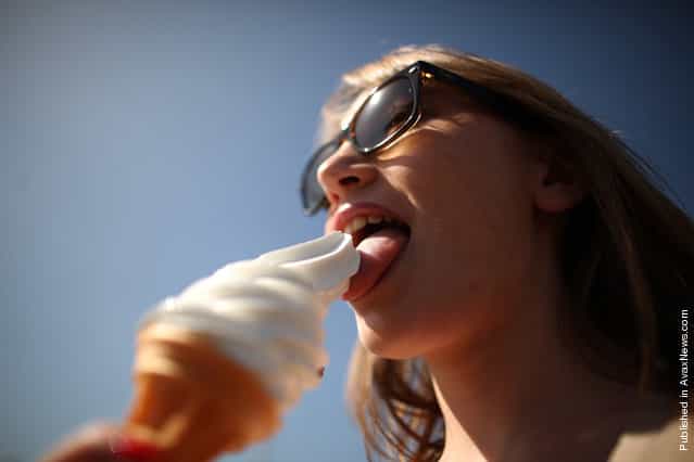 A visitor enjoys an ice cream cone on the seafront on April 9, 2011 in Brighton, England
