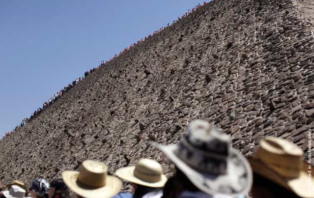People stand in line to climb the Pyramid of the Sun in the pre-hispanic city of Teotihuacan on the outskirts of Mexico City March 20, 2011. Thousands of Mexicans and tourists gather in Teotihuacan every year to welcome the spring equinox