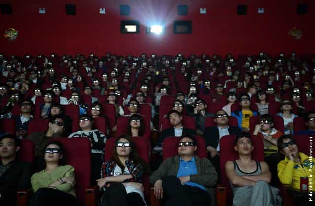 People wearing 3-D glasses watch the film [Titanic 3D] at a movie theater in Taiyuan, China, April 10, 2012
