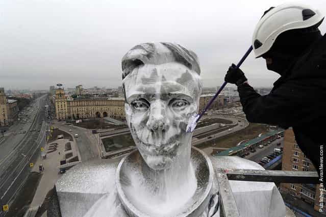 A municipal worker washes the upper part of the 230-foot-high monument to Yuri Gagarin, the first man in space, at Gagarin Square in Moscow, April 11, 2012. Russia celebrated Aviation and Cosmonautics Day, the anniversary of Gagarin making the first manned space flight in 1961