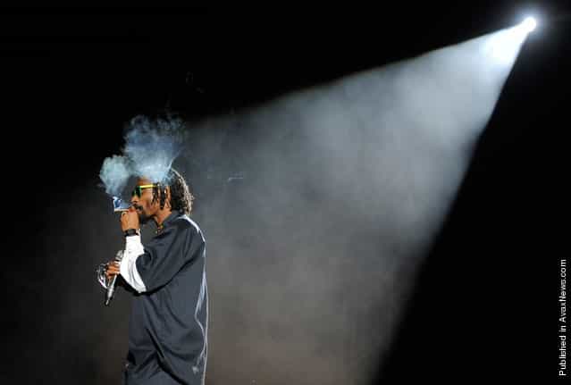 Snoop Dogg smokes onstage during his headlining performance with Dr. Dre on the first weekend of Coachella 2012, on April 15, 2012