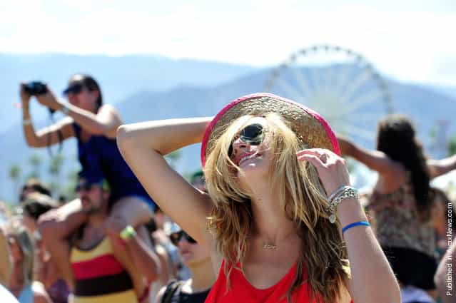 Music fans dance during Day 3 of Coachella 2012, on April 15, 2012