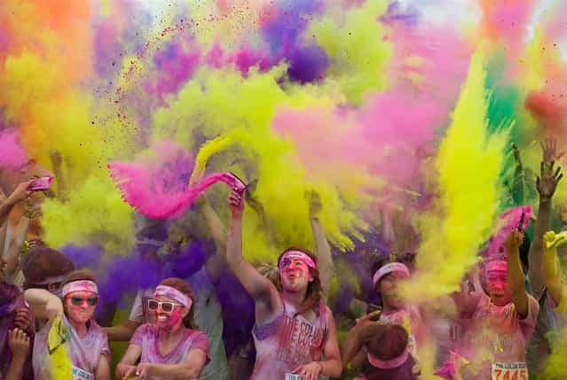 Participants are doused in colors at the finish of the Color Run, a 5-kilometer (3-mile) run at the Great Park in Irvine, Calif., April 22. Racers begin the run in white shirts and as they pass each kilometer they are doused by volunteers with a different color of [magical] dust