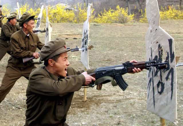 Members of the Worker-Peasant Red Guards of North Korea attend a military training in this picture released by the North’s KCNA news agency in Pyongyang. KCNA said the picture was taken on April 23, 2012. A target (R) reads, (South Korean President) Lee Myung-bak