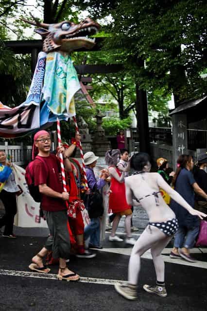 Protesters are accompanied by clowns as they take part in the [Zero Nuclear Power Celebration Parade], as the rally makes its way through the streets of Suginami district, on May 6, 2012 in Tokyo, Japan