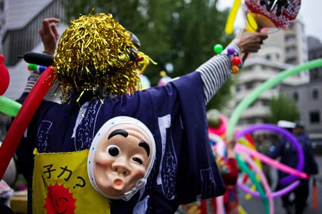 Protesters are accompanied by clowns as they take part in the [Zero Nuclear Power Celebration Parade], as the rally makes its way through the streets of Suginami district, on May 6, 2012 in Tokyo, Japan