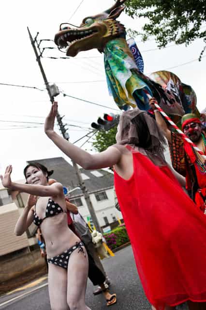 Women dance, in the style of Japanese butoh dancing, as the Zero Nuclear Power Celebration Parade makes its way through the streets of Suginami district, on May 6, 2012 in Tokyo, Japan