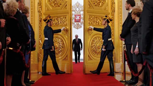 Vladimir Putin enters St. Andrew's Hall to take the oath of office during his inauguration as new Russia's president, in the Grand Kremlin Palace in Moscow. Putin was sworn in as Russia's president for a third term after four years as prime minister