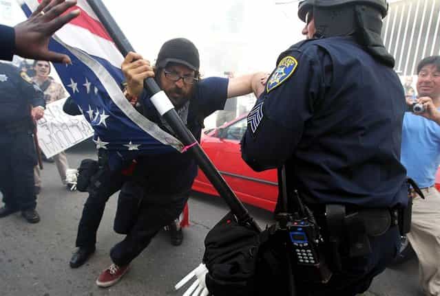 Oakland police officers detain an Occupy protester who was attempting to block a street on May 1, in Oakland, Calif. Occupy Wall Street groups across the country joined with unions on May Day, a traditional day of global demonstrations supporting unions and leftist politics