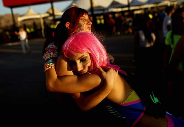 Justine Marsing, right, embraces Andrea Martinez at the Electric Daisy Carnival at the Las Vegas Motor Speedway on June 8, 2012