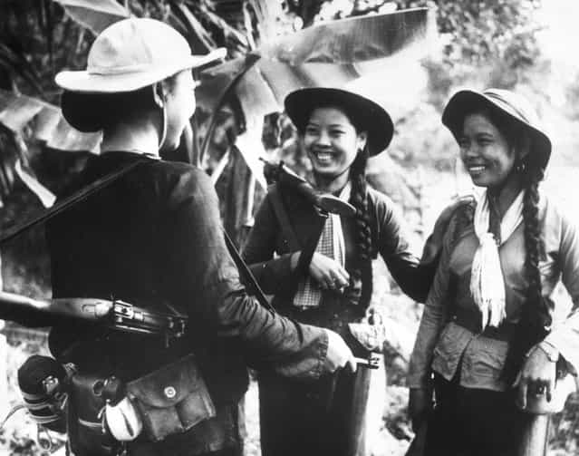 1966: Three young women from South Vietnam with rifles on their shoulders