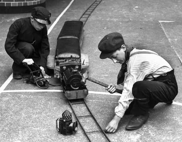 1938: Pupils of the Jews Free Boys School in Bishopsgate, London, working on a model railway made in their wood and metalwork classes in the school playground
