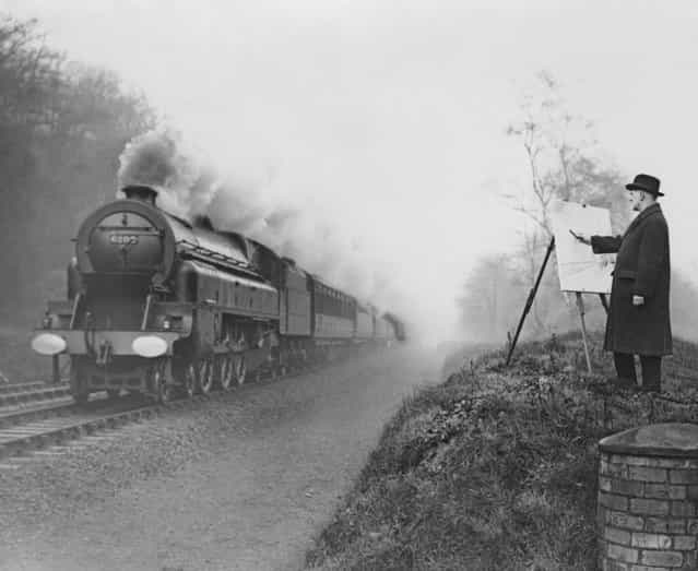 Railway poster artist Norman Wilkinson (1878 - 1971) sketches moving trains on the LMS railway near Watford, Hertfordshire, 15th January 1936