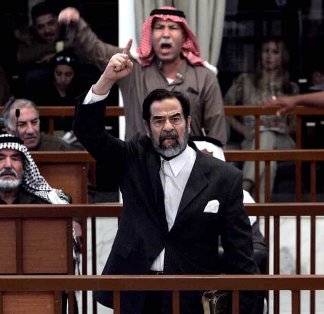 Former Iraqi President Saddam Hussein and Barzan Ibrahim al-Tikriti berate the court during their trial in Baghdad, Monday Dec. 5, 2005