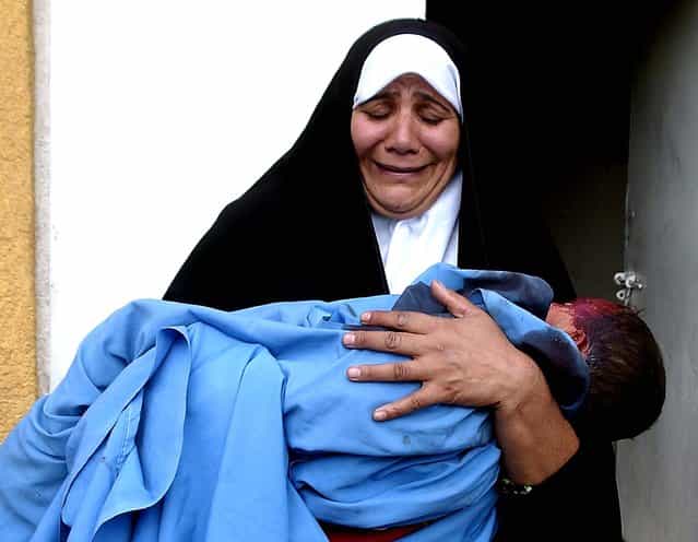 A woman holds the lifeless body of her two-year-old grandson outside Baqoubas hospital, 35 miles northeast of Baghdad, Oct. 31 2006