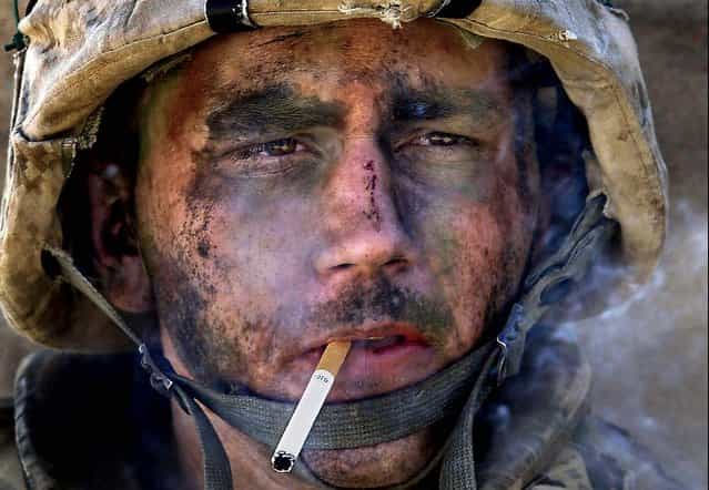 Marine Lance Cpl. James Blake Miller, 20, of Kentucky, a member of Charlie Company of the U.S. Marines First Division, Eighth regiment, smokes a cigarette in Fallujah, Iraq