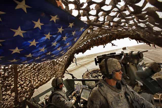 Lt. Col. Richard D. Heyward and Sgt. Nick Wysong keep watch as the Armys 4th Brigade, 2nd Infantry Division, the last formal U.S. military combat detachment to leave Iraq, crosses the southern desert lands of Iraq on August 17, 2010
