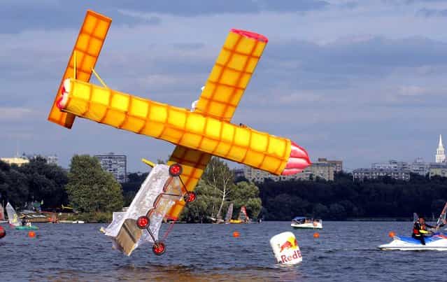 A makeshift aircraft plummets into the Moskva River during the Red Bull Flugtag Moscow 2011 competition. (Photo by Mikhail Metzel/Associated Press)