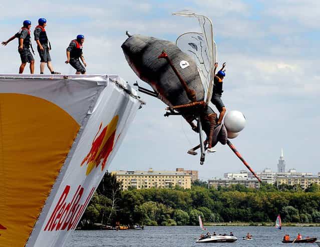 A competitor plunges into the water during the Red Bull Flugtag event in Moscow. (Photo by Natalia Kolesnikova/AFP)