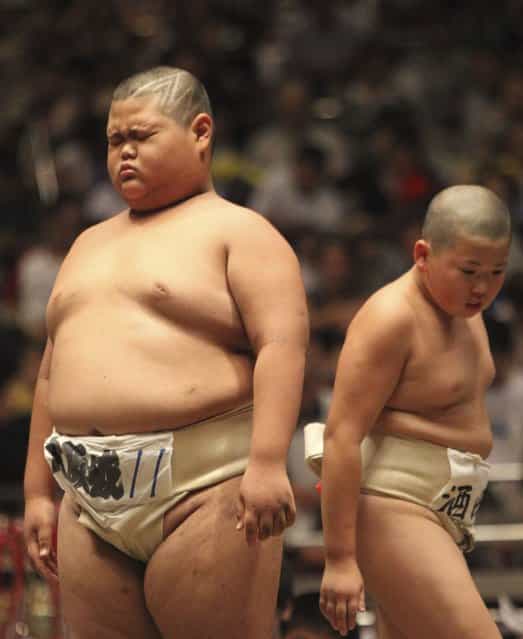 An elementary school sumo wrestler reacts after his bout at the National Children’s Sumo tournament in Tokyo, Japan on July 30, 2012. (Photo by AP Photo)
