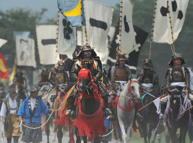 Local people in samurai armor ride their horses during a parade at the annual Soma Nomaoi Festival in Minamisoma, Fukushima Prefecture, on July 29, 2012. Some 400 horses and thousands of people took part in the 1,000-year-old [Soma Nomaoi], or wild horse chase, at the weekend in the shadow of Japans crippled Fukushima nuclear plant. (Photo by Toru Yamanaka/AFP Photo)