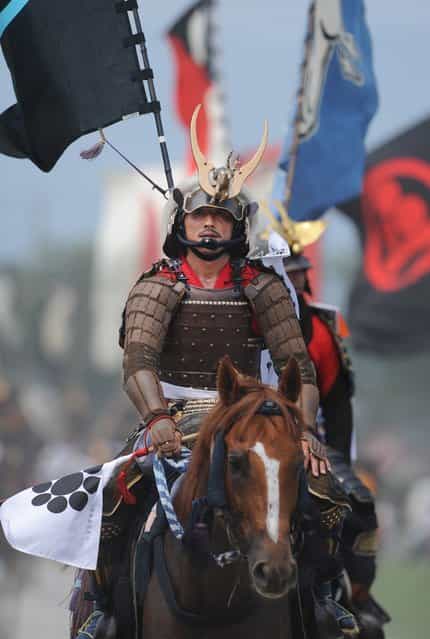 A local man in samurai armor rides his horse during a parade at the annual Soma Nomaoi Festival in Minamisoma, Fukushima Prefecture, on July 29, 2012. Some 400 horses and thousands of people took part in the 1,000-year-old [Soma Nomaoi], or wild horse chase, at the weekend in the shadow of Japans crippled Fukushima nuclear plant. (Photo by Toru Yamanaka/AFP Photo)