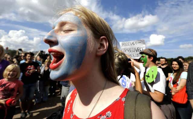 Demonstrators chant slogans in support of the Russian punk group Pussy Riot in St. Petersburg. (Photo by Dmitry Lovetsky/Associated Press)
