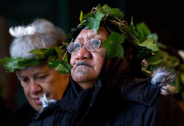 Members of The Tainui Waka Alliance tribe welcome the return of 20 mummified tattooed Maori heads (Toi Moko) that were taken to Europe in the 1700s and 1800s, during a ceremony at Te Papa Museum in Wellington, New Zealand, on January 27, 2012. The tattooed heads were handed over by French officials at the Quai Branly Museum in Paris after a four-year political struggle. The Maori heads were once warriors that tattooed their faces with elaborate geometric designs to show their rank and were an object of fascination for European explorers who collected and traded them from the 18th century onwards. (Photo by Marty Melville/AFP)