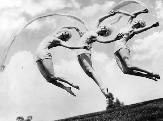 Three Marion Morgan dancing girls caught in mid-air formation, 1926. (Photo by Topical Press Agency)