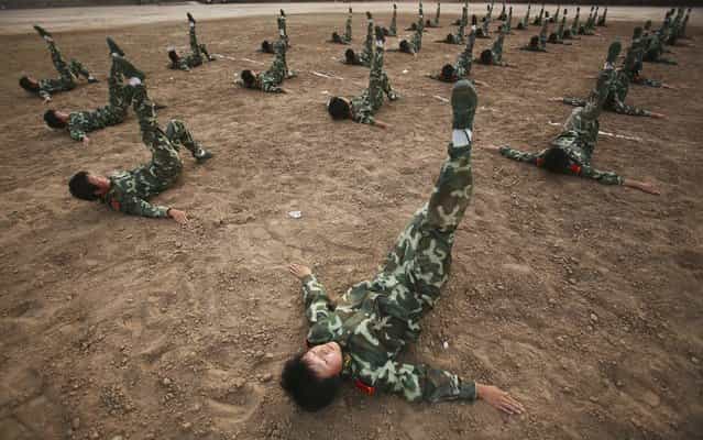 XINING, CHINA - AUGUST 8: (CHINA OUT) Members of a female grappling team from Qinghai Province armed police undergo fistic exercises on August 8, 2006 in Xining of Qinghai Province, China. The female grappling team, established in May 2006, has 40 women soldiers aged 18 to 21. The training program includes grappling, boxing, dagger exercise and shooting. (Photo by China Photos/Getty Images)