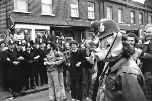 Pickets at Grunwick photo-processing Laboratory in Willesden, London, wearing pig masks and toy policemen's hats, July 1977. (Photo by Graham Morris/Evening Standard)